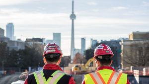 Two individuals looking into the distance at the CN tower.